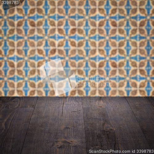 Image of Wood table top and blur vintage ceramic tile pattern wall