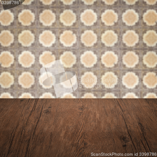 Image of Wood table top and blur vintage ceramic tile pattern wall