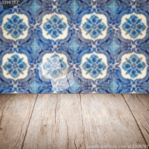 Image of Wood table top and blur vintage ceramic tile pattern wall
