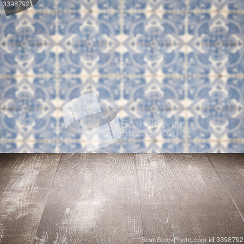 Image of Wood table top and blur vintage ceramic tile pattern wall