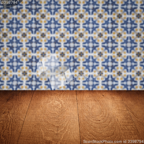 Image of Wood table top and blur vintage ceramic tile pattern wall