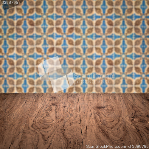 Image of Wood table top and blur vintage ceramic tile pattern wall