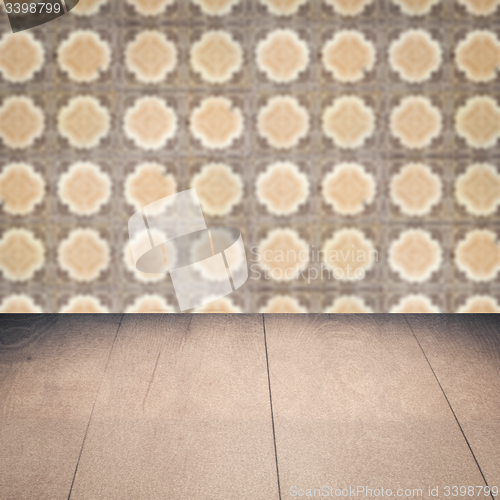 Image of Wood table top and blur vintage ceramic tile pattern wall