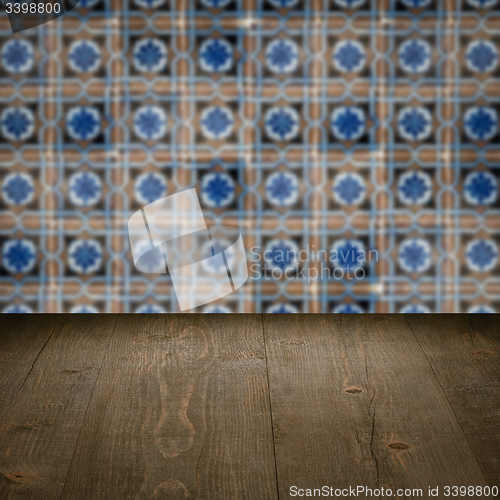 Image of Wood table top and blur vintage ceramic tile pattern wall