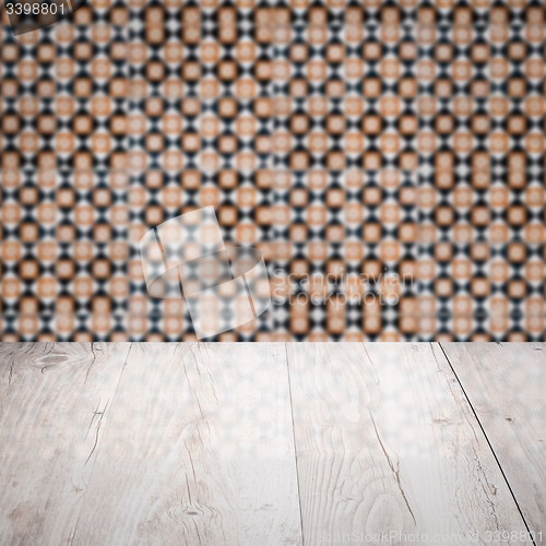 Image of Wood table top and blur vintage ceramic tile pattern wall
