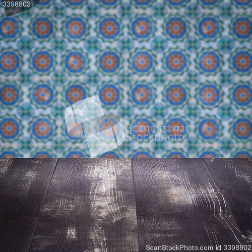 Image of Wood table top and blur vintage ceramic tile pattern wall