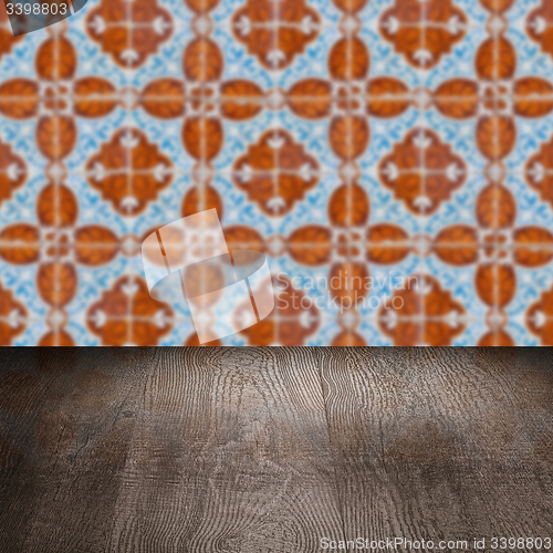 Image of Wood table top and blur vintage ceramic tile pattern wall