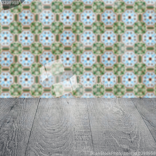 Image of Wood table top and blur vintage ceramic tile pattern wall