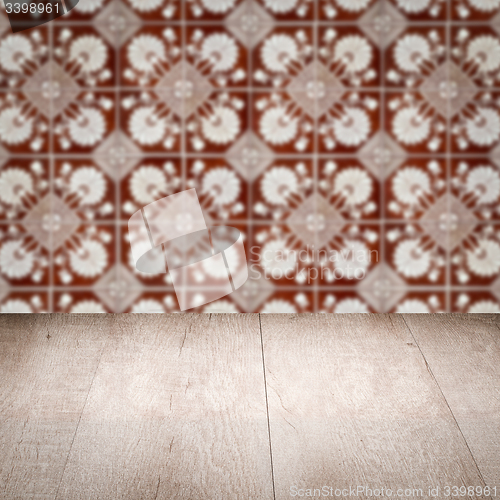 Image of Wood table top and blur vintage ceramic tile pattern wall