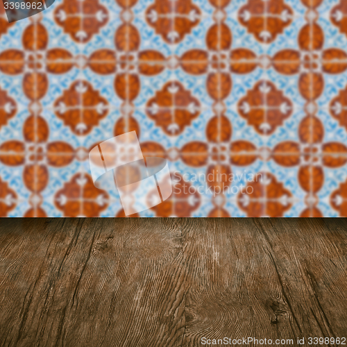 Image of Wood table top and blur vintage ceramic tile pattern wall