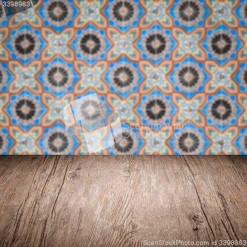 Image of Wood table top and blur vintage ceramic tile pattern wall