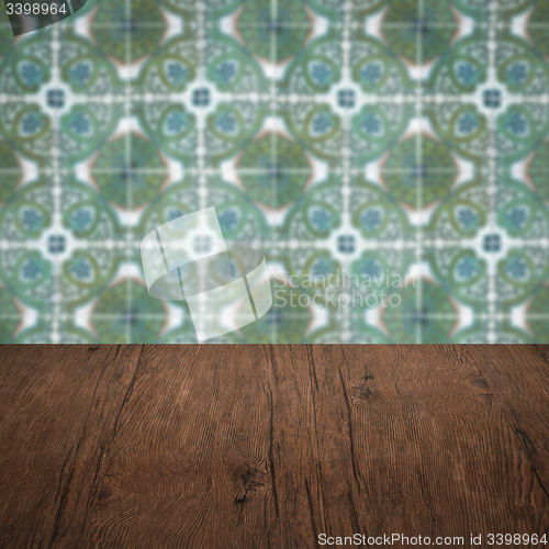 Image of Wood table top and blur vintage ceramic tile pattern wall