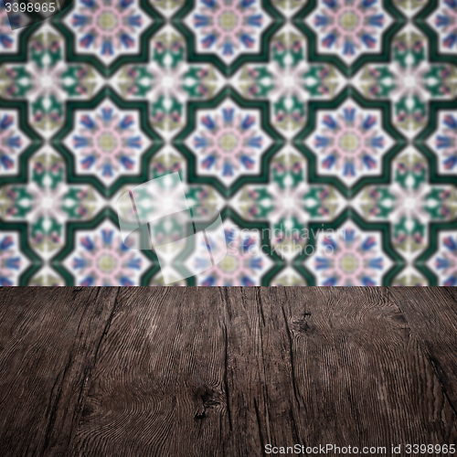 Image of Wood table top and blur vintage ceramic tile pattern wall