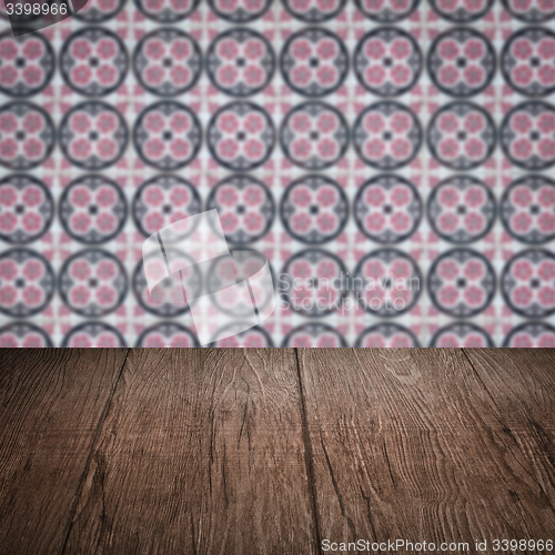 Image of Wood table top and blur vintage ceramic tile pattern wall