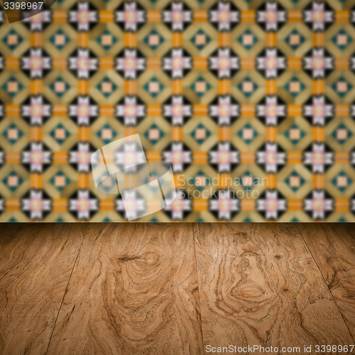 Image of Wood table top and blur vintage ceramic tile pattern wall