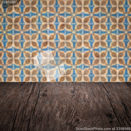 Image of Wood table top and blur vintage ceramic tile pattern wall