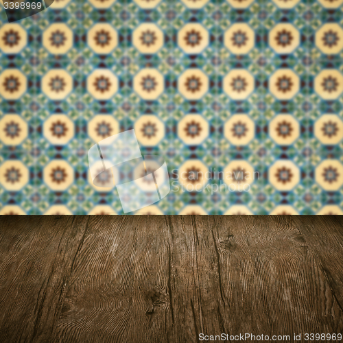 Image of Wood table top and blur vintage ceramic tile pattern wall
