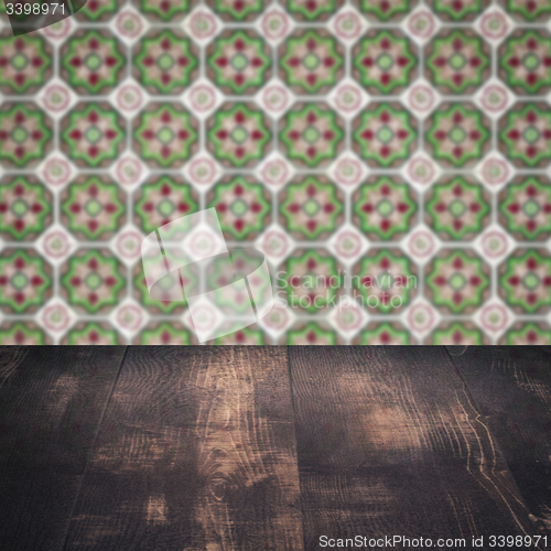 Image of Wood table top and blur vintage ceramic tile pattern wall