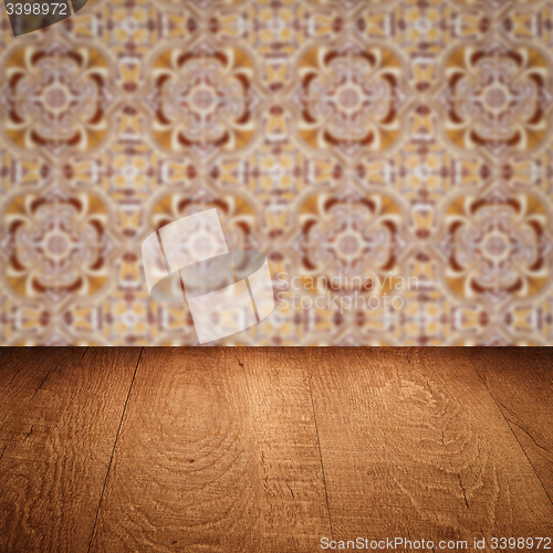 Image of Wood table top and blur vintage ceramic tile pattern wall