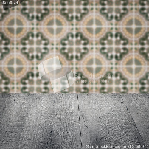 Image of Wood table top and blur vintage ceramic tile pattern wall