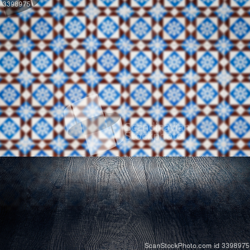 Image of Wood table top and blur vintage ceramic tile pattern wall