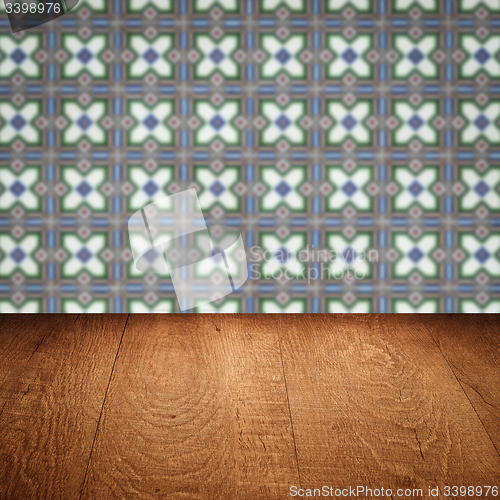 Image of Wood table top and blur vintage ceramic tile pattern wall
