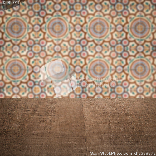 Image of Wood table top and blur vintage ceramic tile pattern wall