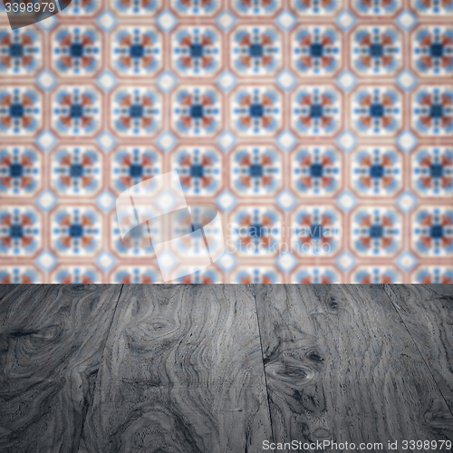 Image of Wood table top and blur vintage ceramic tile pattern wall