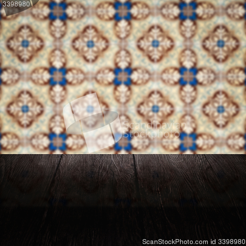 Image of Wood table top and blur vintage ceramic tile pattern wall