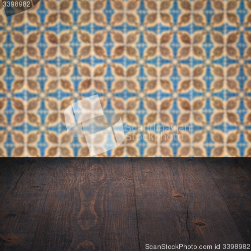 Image of Wood table top and blur vintage ceramic tile pattern wall