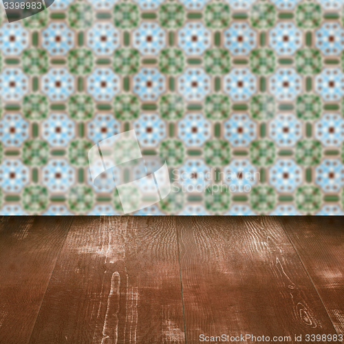 Image of Wood table top and blur vintage ceramic tile pattern wall