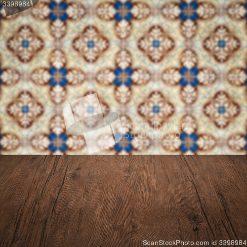 Image of Wood table top and blur vintage ceramic tile pattern wall