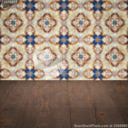 Image of Wood table top and blur vintage ceramic tile pattern wall