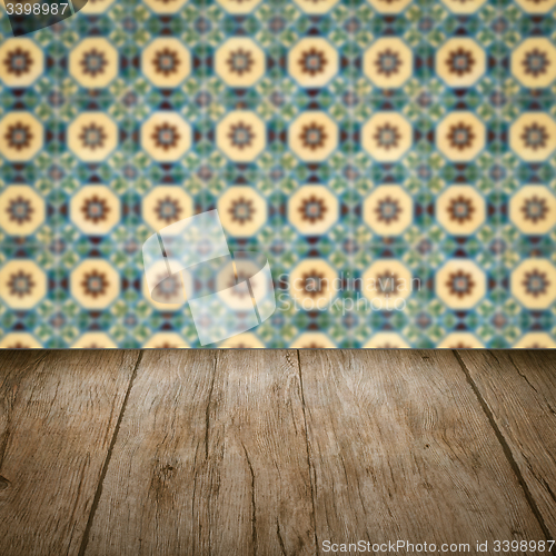 Image of Wood table top and blur vintage ceramic tile pattern wall