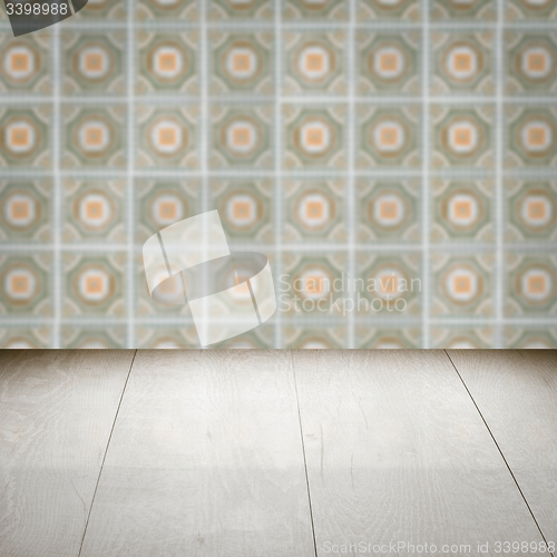 Image of Wood table top and blur vintage ceramic tile pattern wall