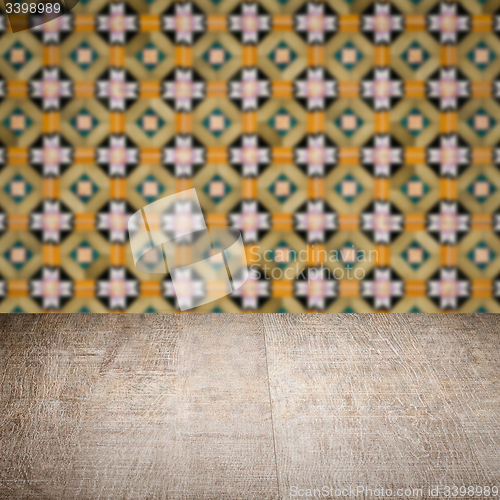 Image of Wood table top and blur vintage ceramic tile pattern wall