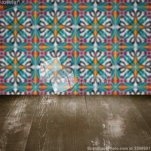 Image of Wood table top and blur vintage ceramic tile pattern wall