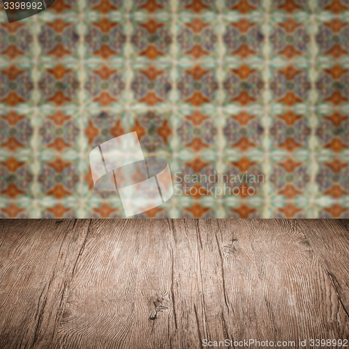 Image of Wood table top and blur vintage ceramic tile pattern wall