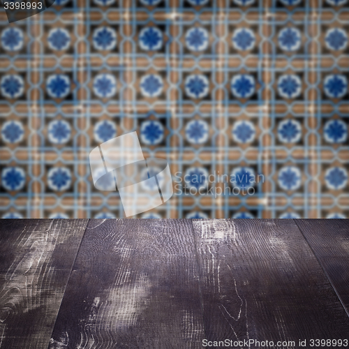 Image of Wood table top and blur vintage ceramic tile pattern wall