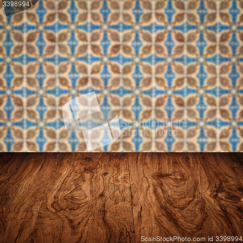 Image of Wood table top and blur vintage ceramic tile pattern wall