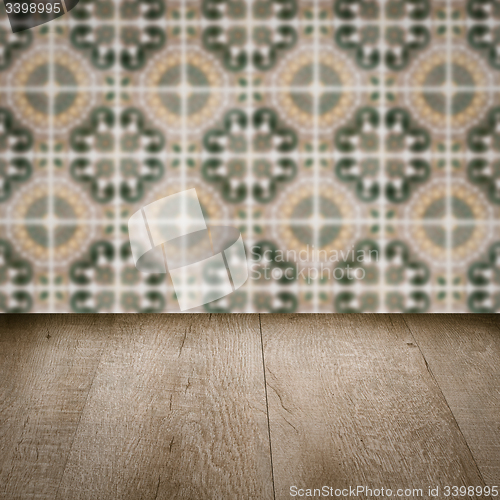 Image of Wood table top and blur vintage ceramic tile pattern wall