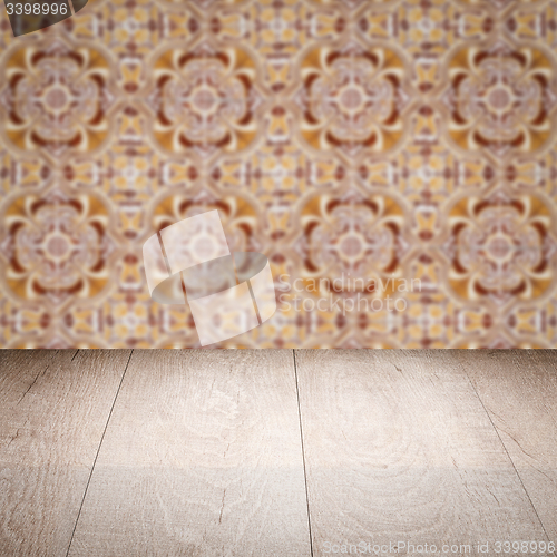 Image of Wood table top and blur vintage ceramic tile pattern wall