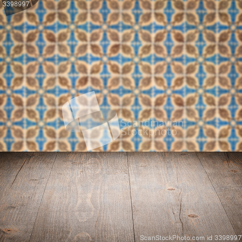 Image of Wood table top and blur vintage ceramic tile pattern wall