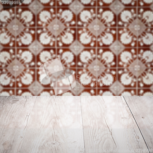 Image of Wood table top and blur vintage ceramic tile pattern wall