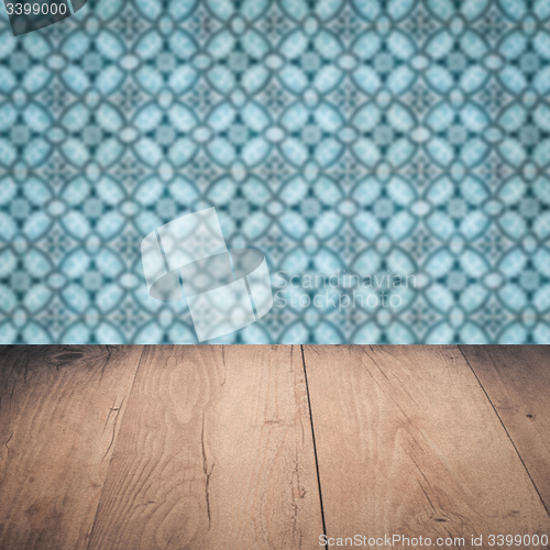 Image of Wood table top and blur vintage ceramic tile pattern wall