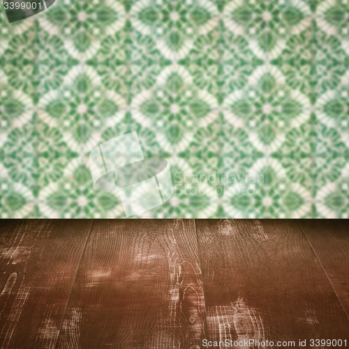 Image of Wood table top and blur vintage ceramic tile pattern wall