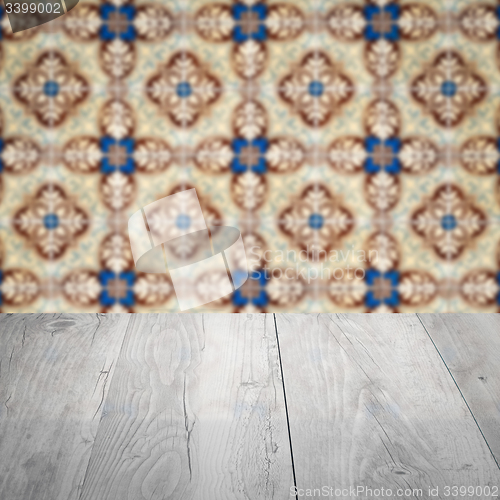 Image of Wood table top and blur vintage ceramic tile pattern wall