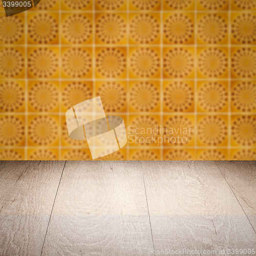 Image of Wood table top and blur vintage ceramic tile pattern wall