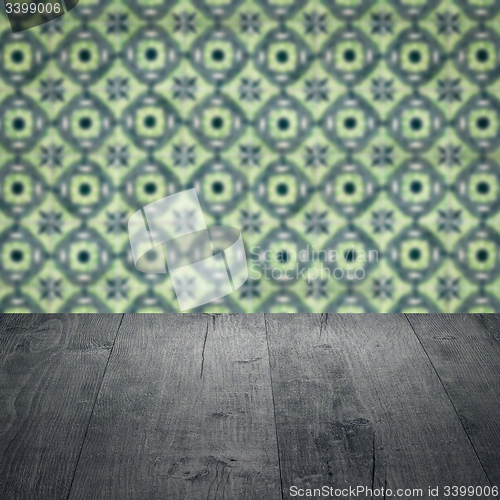 Image of Wood table top and blur vintage ceramic tile pattern wall