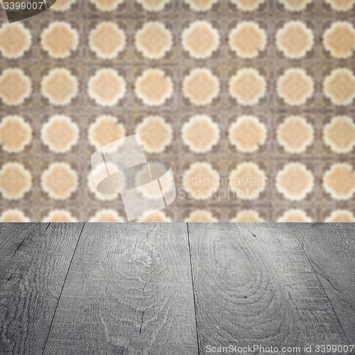 Image of Wood table top and blur vintage ceramic tile pattern wall